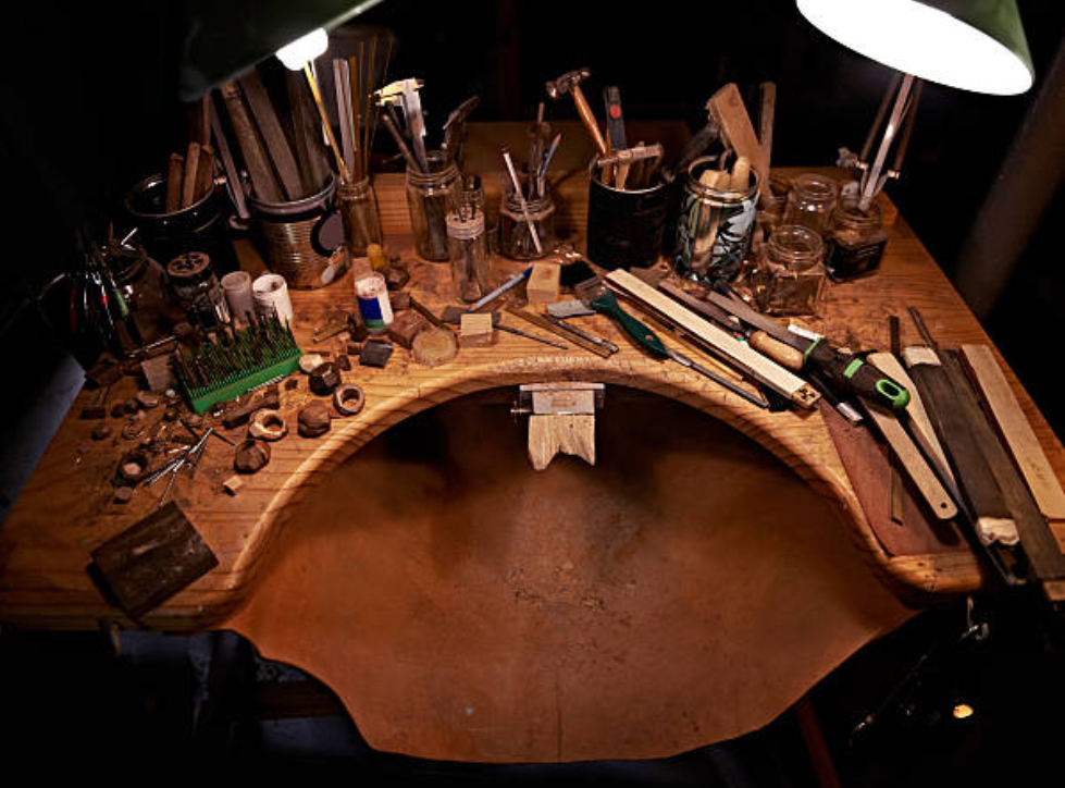 Professional jewelry making workbench with essential tools - pliers, files, measuring instruments and soldering equipment for beginners
