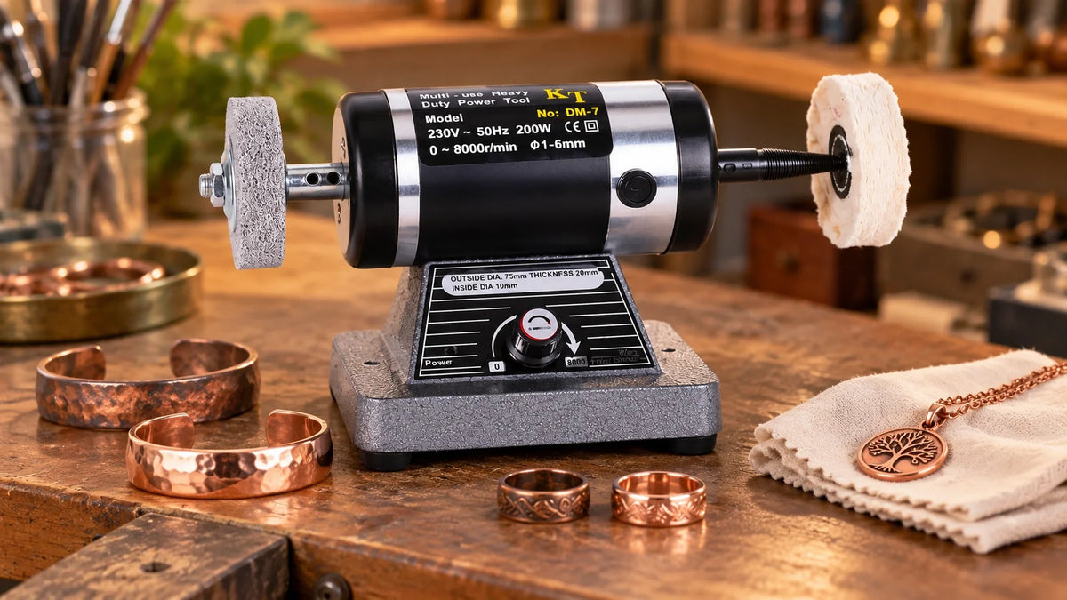 Tooltos bench polishing machine with dual polishing wheels on a workbench beside copper jewelry