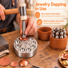 Jeweler using a mallet and ball-ended dapping punch to shape a copper blank over a round dapping die.