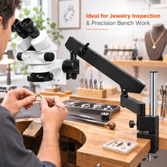 Jewelry worker using a stereo microscope with articulating boom stand for close inspection