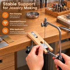 Jeweler sawing a small metal sheet supported on a wooden bench pin clamped to the edge of a workbench.